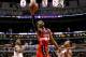 Washington Wizards guard John Wall (2) scores between the defense of Chicago Bulls guard Jimmy Butler, left, and Derrick Rose during the second half of an NBA basketball game, Monday, Jan. 11, 2016, in Chicago. The Wizards won 114-100. (AP Photo/Charles Rex Arbogast)