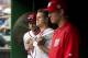 From left to right, Washington Nationals pitchers Max Scherzer, Jonathan Papelbon and Stephen Strasburg watch the eighth inning of a baseball game against the Philadelphia Phillies at Nationals Park in Washington, Sunday, Sept. 27, 2015, after Papelbon got into a dugout fight with teammate Bryce Harper during the inning. The Phillies won 12-5. (AP Photo/Jacquelyn Martin)