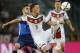 United States' Ventura Alvarado, left, Germany's Mesut Ozil challenge for the ball during the soccer friendly match between Germany and the United States in Cologne, western Germany, Wednesday, June 10, 2015. (AP Photo/Frank Augstein)