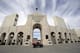 A worker rides past the entrance of The Los Angeles Memorial Coliseum on Wednesday, Jan. 13, 2016. NFL owners voted Tuesday night to allow the St. Louis Rams to move to a new stadium just outside Los Angeles. The Rams, based in the LA area from 1946-94, will play in a temporary facility, probably the Los Angeles Coliseum, until the new stadium is ready, most likely for the 2019 season. (AP Photo/Nick Ut)