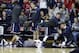 Monmouth players react on the bench to a play during the first half of an NCAA college basketball game against Rutgers, Sunday, Dec. 20, 2015, in Piscataway, N.J. (AP Photo/Mel Evans)