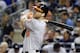 FILE - In this Sept. 8, 2015, file photo, Baltimore Orioles' Chris Davis hits a home run during the ninth inning of a baseball game against the New York Yankees in New York. The Orioles have withdrawn their multi-million dollar offer to free agent first baseman Chris Davis, executive vice president Dan Duquette said Saturday, Dec. 12, 2015. (AP Photo/Frank Franklin II, File)