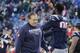 New England Patriots head coach Bill Belichick walks past New England Patriots defensive end Chandler Jones (95) as the team warms up before an NFL divisional playoff football game against the Kansas City Chiefs, Saturday, Jan. 16, 2016, in Foxborough, Mass. (AP Photo/Elise Amendola)