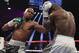 Floyd Mayweather Jr. (L) lands on punch on Andre Berto during the fight for the WBO Welterweight World Title at the MGM Grand Garden Arena in Las Vegas, Nevada on September 12, 2015. Floyd Mayweather earned a unanimous decision over Andre Berto to claim his 49th and he says final victim in a glittering unbeaten ring career spanning two decades. AFP PHOTO/JOHN GURZINSKI (Photo credit should read JOHN GURZINSKI/AFP/Getty Images)