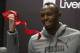 Jamaican sprinter Usain Bolt smiles after cutting a ribbon during a promotional event for Puma at a department store, in Mexico City, Wednesday, Oct. 7, 2015. (AP Photo/Rebecca Blackwell)