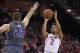 Maryland guard Melo Trimble (2) puts up a shot against Northwestern center Alex Olah (22) during the second half of an NCAA college basketball game, Tuesday, Jan. 19, 2016, in College Park, Md. Maryland won 62-56 in overtime. (AP Photo/Nick Wass)