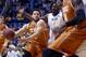 Texas guard Javan Felix (3) drives past West Virginia forward Jonathan Holton (1) during the first half of an NCAA college basketball game, Wednesday, Jan, 20, 2016, in Morgantown, W.Va. (AP Photo/Raymond Thompson)