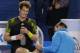 Britain's Andy Murray reacts as a trainer treats a foot injury during the men's final against Serbia's Novak Djokovic at the Australian Open tennis championship in Melbourne, Australia, Sunday, Jan. 27, 2013. (AP Photo/Aaron Favila)