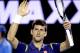 Novak Djokovic of Serbia raises his arms in celebration after defeating Quentin Halys of France in their second round match at the Australian Open tennis championships in Melbourne, Australia, Wednesday, Jan. 20, 2016.(AP Photo/Vincent Thian)