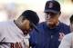 Boston Red Sox third baseman Pablo Sandoval, left, is checked out by a trainer, right, and manager John Farrell, middle, during the fifth inning of a baseball game against the Kansas City Royals at Kauffman Stadium in Kansas City, Mo., Saturday, June 20, 2015. Sandoval left the game. (AP Photo/Orlin Wagner)