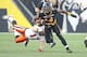 HAMILTON, ON - AUGUST 15: Terrell Sinkfield Jr. #14 of the Hamilton Tiger-Cats eludes a tackle against the BC Lions during a CFL football game at Tim Hortons Field on August 15, 2015 in Hamilton, Ontario, Canada. The Tiger-Cats defeated the Lions. (Photo by Claus Andersen/Getty Images)