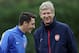 Arsenal's German midfielder Mesut Ozil (L) and Arsenal's French manager Arsene Wenger speak during a training session at the club's complex in London Colney, on September 17, 2013. Arsenal travel to play Olympique Marseille in a UEFA Champions League match Wednesday. AFP PHOTO / ADRIAN DENNIS (Photo credit should read ADRIAN DENNIS/AFP/Getty Images)