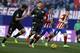 Atletico Madrid's Antoine Griezmann, second right, runs with the ball next to Sevilla's Grzegorz Krychowiak, left, and Fernando Llorente, second left, during a Spanish La Liga soccer match between Atletico Madrid and Sevilla at the Vicente Calderon stadium in Madrid, Sunday, Jan. 24, 2016. The match ended in a 0-0 draw. (AP Photo/Francisco Seco)