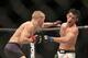 Dominick Cruz evades a punch against TJ Dillashaw in their mixed martial arts title bout at UFC Fight Night 81, Sunday, Jan. 17, 2016, in Boston. Cruz won via split decision and is the new UFC Bantamweight Champion. (AP Photo/Gregory Payan)