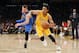 Los Angeles Lakers' D'Angelo Russell, right, attempts to drive past Dallas Mavericks' J.J. Barea, left, during the second half of an NBA basketball game, Tuesday, Jan. 26, 2016, in Los Angeles. The Mavericks won 92-90. (AP Photo/Danny Moloshok)