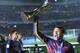 FC Barcelona’s Neymar holds up the trophy as he celebrates winning the final match against River Plate at the FIFA Club World Cup soccer tournament in Yokohama, near Tokyo, Sunday, Dec. 20, 2015. FC Barcelona beat River Plate 3-0. (AP Photo/Eugene Hoshiko)