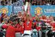 Manchester United captain Nemanja Vidic (C) lifts the English Premier League trophy after their match against Blackpool at Old Trafford in Manchester, north west England, on May 22, 2011. United celebrated winning the league for a 19th time beating Liverpool's long standing record. AFP PHOTO/PAUL ELLISFOR EDITORIAL USE ONLY Additional licence required for any commercial/promotional use or use on TV or internet (except identical online version of newspaper) of Premier League/Football League photos. Tel DataCo +44 207 2981656. Do not alter/modify photo. (Photo credit should read PAUL ELLIS/AFP/Getty Images)