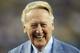 Los Angeles Dodgers broadcaster Vin Scully is honored before a baseball game against the Arizona Diamondbacks in Los Angeles, Wednesday, Sept. 23, 2015. Scully was given a Guinness World Records certificate for the longest career as a sports broadcaster for a single team, and the team honored him with a bobble head for all of the fans in attendance. (AP Photo/Alex Gallardo)