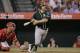 Oakland Athletics' Stephen Vogt hits a two-run single to lead the game during the seventh inning of a baseball game against the Los Angeles Angels, Wednesday, Sept. 30, 2015, in Anaheim, Calif. (AP Photo/Jae C. Hong)
