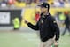 Michigan head coach Jim Harbaugh on the field during the first half of the Citrus Bowl NCAA college football game against Florida , Friday, Jan. 1, 2016, in Orlando, Fla. (AP Photo/John Raoux)