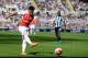 Arsenal's English midfielder Alex Oxlade-Chamberlain takes the shot which deflects off Newcastle United's Argentinian defender Fabricio Coloccini (not pictured) for Arsenal's opening goal in the English Premier League football match between Newcastle United and Arsenal at St James' Park in Newcastle-upon-Tyne, north east England, on August 29, 2015. AFP PHOTO / OLI SCARFF RESTRICTED TO EDITORIAL USE. No use with unauthorized audio, video, data, fixture lists, club/league logos or 'live' services. Online in-match use limited to 75 images, no video emulation. No use in betting, games or single club/league/player publications. (Photo credit should read OLI SCARFF/AFP/Getty Images)