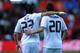 GIJON, SPAIN - NOVEMBER 14: Gonzalo Higuain of Real Madrid celebrates with team mate Mesut Ozil after scoring a goal during the La Liga match between Sporting Gijon and Real Madrid at El Molinon Stadium on November 14, 2010 in Gijon, Spain. (Photo by Denis Doyle/Getty Images)