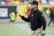 Michigan head coach Jim Harbaugh on the field during the first half of the Citrus Bowl NCAA college football game against Florida , Friday, Jan. 1, 2016, in Orlando, Fla. (AP Photo/John Raoux)
