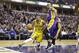 Indiana Pacers guard George Hill (3) cuts under Los Angeles Lakers center Robert Sacre (50) during the second half of an NBA basketball game in Indianapolis, Monday, Feb. 8, 2016. The Pacers defeated the Lakers 89-87. (AP Photo/Michael Conroy)