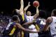 LAWRENCE, KS - FEBRUARY 9: Perry Ellis #34 of the Kansas Jayhawks shoots against Nathan Adrian #11, Jevon Carter #2 and Devin Williams #41 of the West Virginia Mountaineers in the first half at Allen Fieldhouse on February 9, 2015 in Lawrence, Kansas. (Photo by Ed Zurga/Getty Images)
