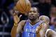 Oklahoma City Thunder's Kevin Durant (35) reaches out to catch a pass in front of Phoenix Suns' P.J. Tucker, right, during the second half of an NBA basketball game Monday, Feb. 8, 2016, in Phoenix. The Thunder defeated the Suns 122-106. (AP Photo/Ross D. Franklin)