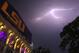 Lightning bolts are seen over Tiger Stadium during a weather delay at an NCAA college football game between LSU and McNeese State in Baton Rouge, La., Saturday, Sept. 5, 2015. The game was canceled due to weather. (AP Photo/Jonathan Bachman)
