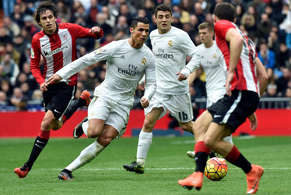 Real Madrid's Portuguese forward Cristiano Ronaldo (2ndL) runs with the ball during the Spanish league football match Real Madrid CF vs Athletic Club Bilbao at the Santiago Bernabeu stadium in Madrid on February 13, 2016. / AFP / GERARD JULIEN        (Photo credit should read GERARD JULIEN/AFP/Getty Images)