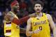 Cleveland Cavaliers' LeBron James (23) and Kevin Love (0) talk after a timeout during the first half of an NBA basketball game against the Phoenix Suns on Monday, Dec. 28, 2015, in Phoenix. (AP Photo/Ross D. Franklin)