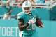 Miami Dolphins running back Lamar Miller (26) carries the ball during the first half of an NFL football game against the New England Patriots, Sunday, Jan. 3, 2016 in Miami Gardens, Fla. (AP Photo/Wilfredo Lee)