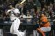 Seattle Mariners' Nelson Cruz and Houston Astros catcher Hank Conger watch Cruz' sacrifice fly in the first inning of a baseball game, Tuesday, Sept. 29, 2015, in Seattle. (AP Photo/Ted S. Warren)