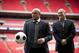 Former Brazil national soccer team player Roberto Carlos holds a ball as he attends a group photo session pitchside as a guest of FIFA Presidential Candidate Gianni Infantino after unveiling his 90 day plan that he will implement if he is elected FIFA President, at Wembley Stadium in London, Monday, Feb. 1, 2016. (AP Photo/Matt Dunham)
