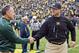 Mark Dantonio and Jim Harbaugh will meet at midfield before another edition of the in-state rivalry.