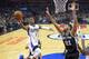 Los Angeles Clippers guard Chris Paul, left, shoots as San Antonio Spurs center Tim Duncan defends during the first half of an NBA basketball game Thursday, Feb. 18, 2016, in Los Angeles. (AP Photo/Mark J. Terrill)