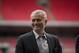 Former Chelsea manager Jose Mourinho smiles as he attends a group photo session pitchside as a guest of FIFA Presidential Candidate Gianni Infantino after unveiling his 90 day plan that he will implement if he is elected FIFA President, at Wembley Stadium in London, Monday, Feb. 1, 2016. (AP Photo/Matt Dunham)