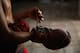 HAVANA, CUBA - MAY 09: Jaime Poradius, 16-years-old, takes off his boxing gloves after a training session at the Salvador Allende Sports Complex on May 9, 2015 in Alamar, Cuba. Alamar is a suburb of Havana. The town, which is about 30 minutes east of Havana, was built in the 1970Õs when the city center to supply much need housing to the people of Cuba. The gym where kids work out here is run by a coach Lazaro Goyalo Perez Quintana. The gym is not much of a gym, but rather a small room under a now-empty Olympic size swimming pool. The room has one light, one punching bag, and a couple of bags filled with sand pinned up against the wall for the boxers to train with. Although baseball is known as the national sport of Cuba, boxing in the sport where they have achieved the greatest dominance at the Olympic Games. Since the 1968 Games, Cuba has won a total of 53 medals, and 33 of those have been gold medals Ñ no other country is even close to those numbers. Boxing starts as early as eight-years old for boys in