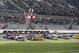 Chase Elliott (24) and Dale Earnhardt Jr (88) lead the field at the start of the first of two qualifying races for Sunday's NASCAR Daytona 500 Sprint Cup series auto race at Daytona International Speedway in Daytona Beach, Fla., Thursday, Feb. 18, 2016. (AP Photo/Terry Renna)
