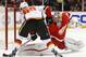Detroit Red Wings goalie Petr Mrazek (34) stops a Calgary Flames center Markus Granlund (60) shot in the third period of an NHL hockey game, Sunday, Dec. 20, 2015 in Detroit. (AP Photo/Paul Sancya)