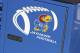 LAWRENCE, KS - OCTOBER 11: A Kansas Jayhawks football logo is seen on a piece of the team's equipment chest during a game against the Oklahoma State Cowboys at Memorial Stadium on October 11, 2014 in Lawrence, Kansas. (Photo by Ed Zurga/Getty Images)
