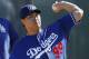 Los Angeles Dodgers' Hyun-Jin Ryu, of South Korea, throws a pitch during a spring training baseball workout Friday, Feb. 26, 2016, in Glendale, Ariz. (AP Photo/Ross D. Franklin)