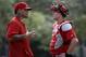 St. Louis Cardinals catcher Yadier Molina, left, talks with fellow catcher Carson Kelly during spring training baseball practice Sunday, Feb. 21, 2016, in Jupiter, Fla. (AP Photo/Jeff Roberson)