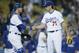 Los Angeles Dodgers catcher Yasmani Grandal, left, and relief pitcher Josh Ravin, right, celebrate after the Dodgers defeated the Arizona Diamondbacks 9-3 in a baseball game, Monday, June 8, 2015, in Los Angeles. (AP Photo/Danny Moloshok)
