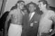 Coach Jess Hill of USC stands with halfback Rudy Bukich, right, who threw the game-winning Rose Bowl game pass against Wisconsin, and halfback Al Carmichael, left, who caught it, Jan. 1, 1953, in Pasadena, Calif. (AP Photo)