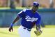Los Angeles Dodgers' Yasiel Puig reaches out to make a catch on a baseball during outfield drills during a spring training baseball workout Friday, Feb. 26, 2016, in Glendale, Ariz. (AP Photo/Ross D. Franklin)