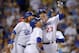 Los Angeles Dodgers' Adrian Gonzalez, right, takes a mock selfie with Justin Turner, left, and Kike Hernandez after hitting a three-run home run during the fifth inning of a baseball game against the Cincinnati Reds, Friday, Aug. 14, 2015, in Los Angeles. (AP Photo/Mark J. Terrill)