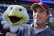 Former Boston College quarterback Doug Flutie stands on the sidelines next to the team mascot after being honored on the 30th anniversary of the 1984 team's